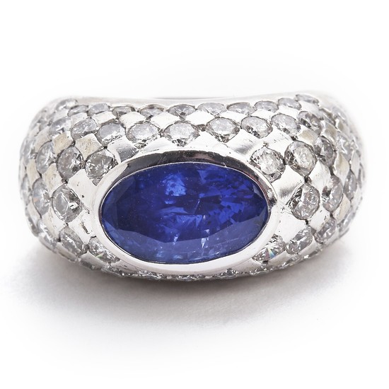 A sapphire and diamond ring set with an oval-cut sapphire weighing app. 3.00 ct. and numerous brilliant-cut diamonds, mounted in 18k white gold. Size 53.