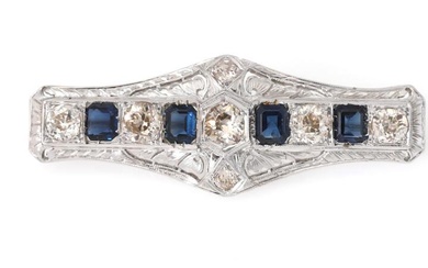 A sapphire brooch set with four emerald-cut sapphires weighing a total of...