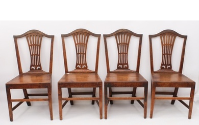 A set of four George III provincial oak dining chairs - with...