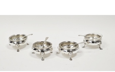 A set of four George V circular silver open salts, with clea...