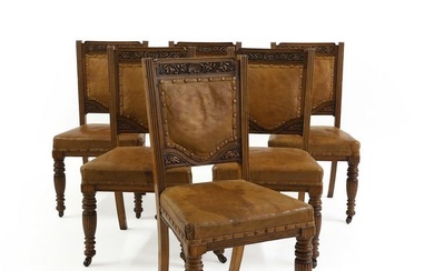 A set of six Victorian oak and leather chairs