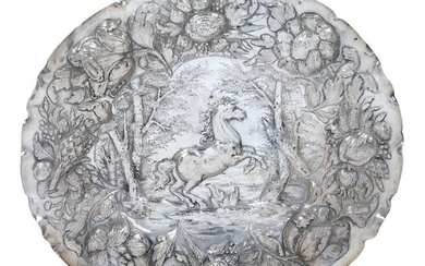 A silver repousse dish, probably German, 17th century, the floral and fruit border surrounding a rearing horse in wooded clearing, 21.6 x 24.5cm, approx. weight 5.9oz Provenance: Reputedly purchased at Christie's New York in 1990. The Geoffrey and...