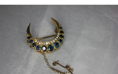 A small 9ct gold crescent brooch set eleven sapphires and th...