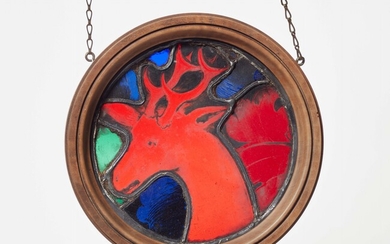 A stained glass panel with a stag's head