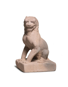 A stone figure of a seated lion