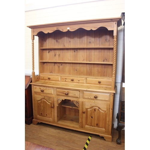 A stripped pine dresser with plate rack and spice drawers, a...