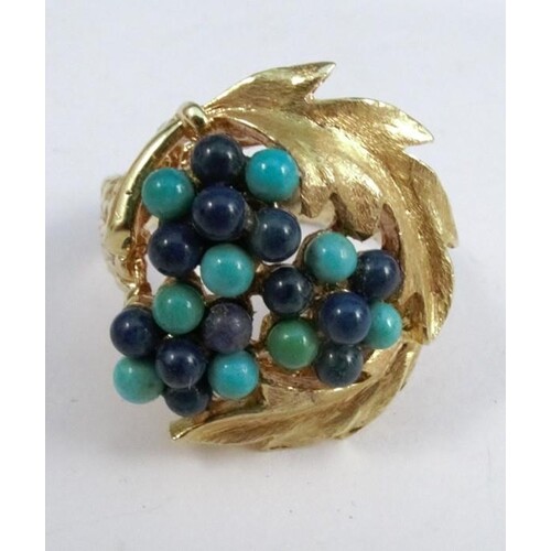 A turquoise and sodalite bead set ring, engraved '750', the ...