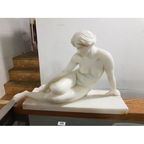 A white marble statue of a female nude (damage to foot)