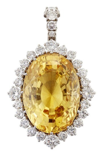 A yellow sapphire and diamond pendant, the oval mixed star / step cut yellow sapphire, weighing 70.87 carats, dimensions 26.92 x 19.48 x 14.46mm, in claw mount to a brilliant-cut diamond surround and graduated line surmount, length 4.8cm...