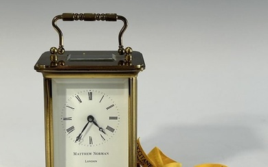 AN ANTIQUE MATHEW NORMAN LONDON BRASS CARRIAGE CLOCK WITH KEY, 19TH CENTURY