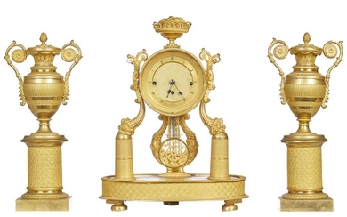 AN AUSTRO-HUNGARIAN EMPIRE STYLE CLOCK AND URN SHAPED CANDLESTICK GARNITURE