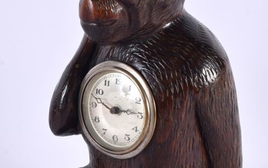 AN UNUSUAL LATE 19TH CENTURY BAVARIAN BLACK FOREST CARVED LINDEN WOOD CLOCK formed as a seated wise