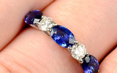 An 18ct gold alternating oval-shape sapphire and brilliant-cut diamond line ring.