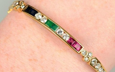 An 18ct gold brilliant-cut diamond, sapphire, emerald and ruby hinged bangle.Estimated total diamond