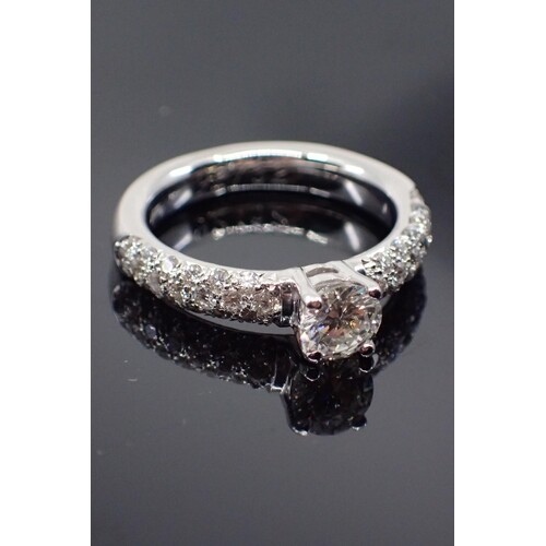 An 18ct gold diamond solitaire ring set with diamond shoulde...