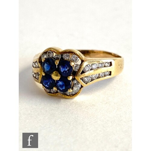 An 18ct sapphire and diamond cluster ring, four central sapp...