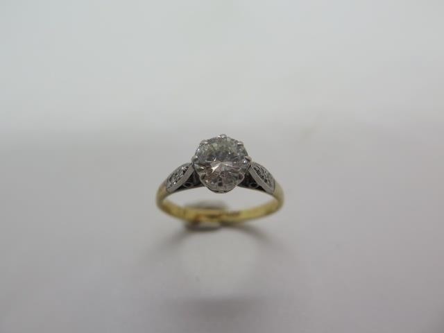 An 18ct yellow gold and platinum solitaire diamond ring set ...