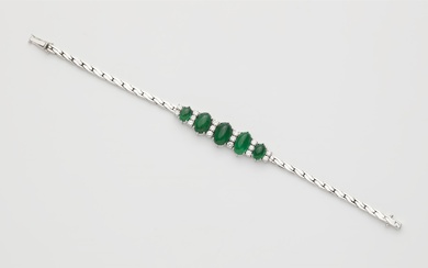 An 18k white gold diamond and emerald cabochon bracelet.