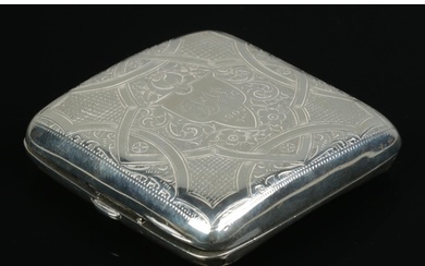 An Edwardian hinged silver cigarette case, with heavily engr...