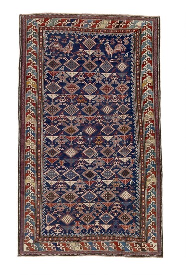 An antique Shirvan rug, Caucasus. All over stylized flowers in lattice design, top with two cocks surrounded by a stepped border. 1890–1910. 214×129 cm.
