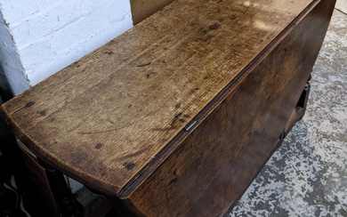 An early 18th century oak drop leaf dining table...