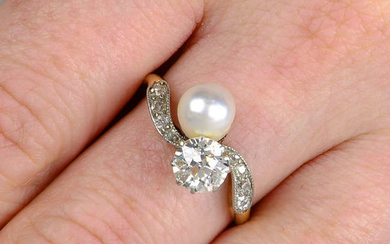 An early 20th century 18ct gold and silver diamond and natural pearl two-stone crossover ring.
