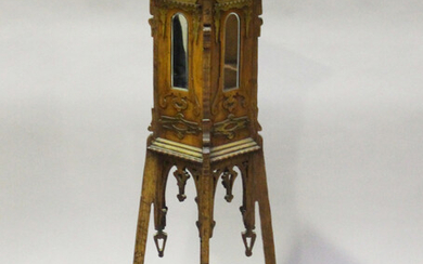 An early 20th century Arts and Crafts oak and softwood display pedestal, the sides with applied fret