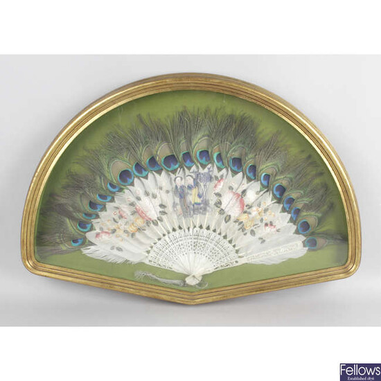 An early 20th century Chinese hand painted fan with peacock feathers