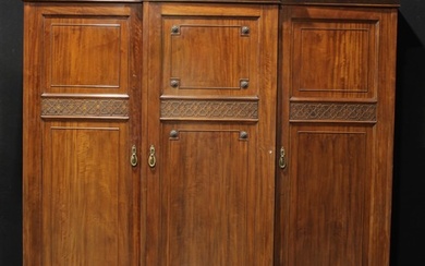 An early 20th century mahogany break-centre triple wardrobe,...