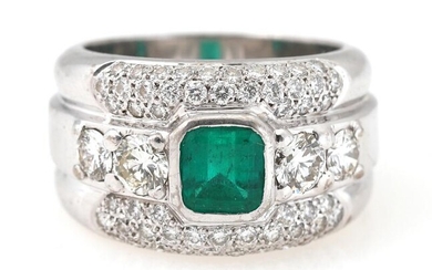 An emerald and diamond ring set with an octagon-cut Colombian emerald weighing...