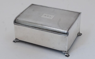 An engine-turned silver cigarette box, Birmingham, 1936, Bravingtons Ltd, the hinged lid with engine turned design and with initialled MNL, with wood lined interior, on ogee bracket feet, 6.5cm high, 14.5cm wide, 10.5cm deep, gross weight approx...