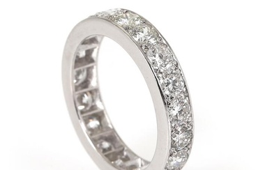 An eternity diamond ring set with numerous brilliant-cut diamonds weighing a total...
