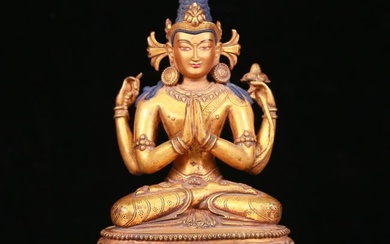 An exquisite gilt bronze statue of Guanyin with four arms
