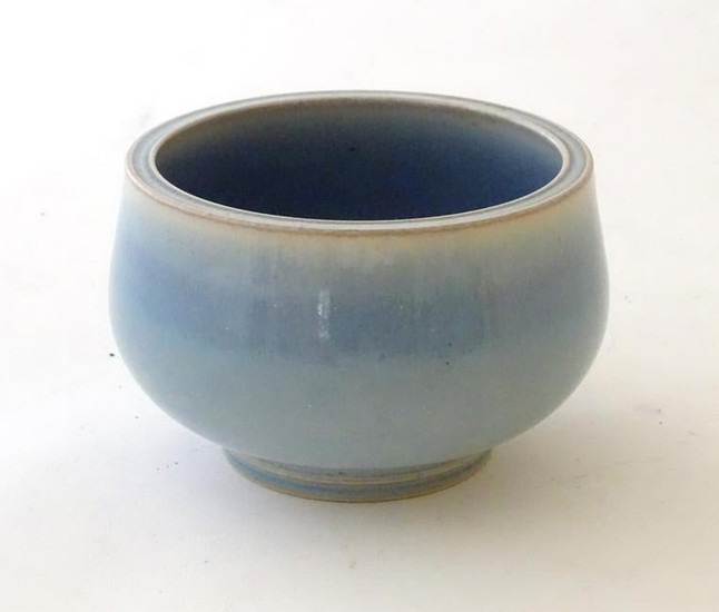 An unmarked high fired blue glazed bowl. Approx 3''