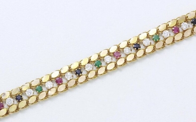 Articulated stylized bracelet in 585 thousandths gold decorated with rubies, sapphires and emeralds in claw setting and white stones. It is embellished with a chased lobster clasp.