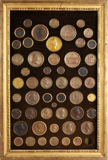 CELEBRATED PERSONALITIES.Large antique giltwood frame, rectangular in shape, containing 56 bronze medals. Each piece is signed André Galle (1761-1844) and engraved on one side. They represent among others: Emperor Napoleon, Tsar Alexander I of...
