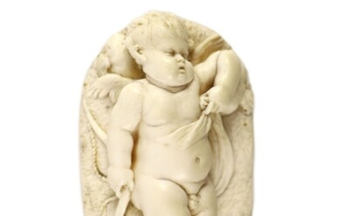 D'après Francois du Quesnoy (1594-1643). Un relief ovale en ivoire représentant un Cupidon endormi, probablement...