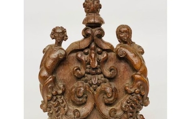 Decorative element in patinated oak representing 2 caryatids...