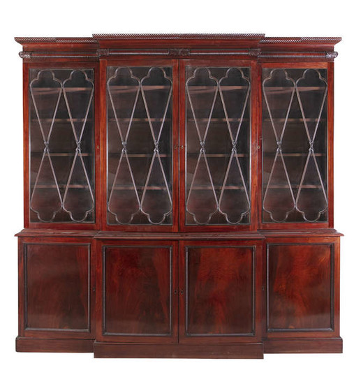 Description A GEORGE IV MAHOGANY BREAKFRONT BOOKCASE, the gadroon...