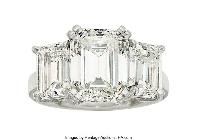 Diamond, Platinum Ring The ring centers an emerald-cut diamond...