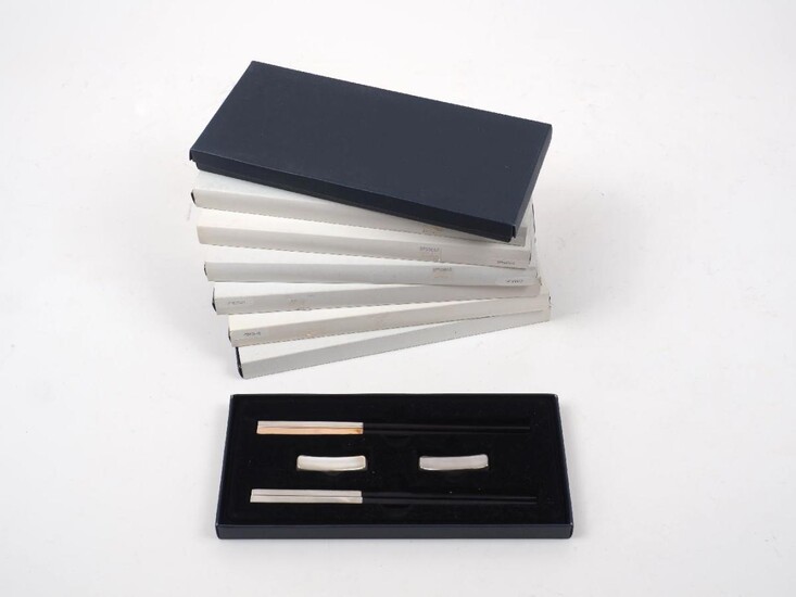 Eight cased sets of white metal mounted wooden chopsticks, each set comprising two pairs of chopsticks, the metal unmarked, assumed silver plated (8 sets)