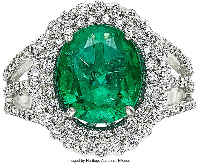 Emerald, Diamond, White Gold Ring The ring centers an...