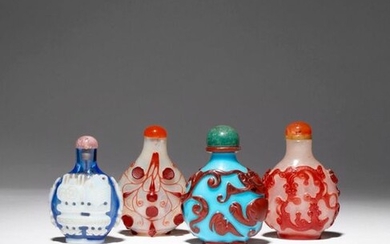 FOUR CHINESE OVERLAY GLASS SNUFF BOTTLES 19TH CENTURY The smallest...