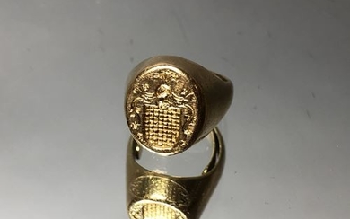 Golden signet ring, surmounted by a knight's helmet...