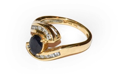 Gross weight 5.2 grams. A sapphire and diamond ring,...
