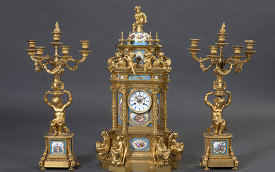 Important table clock with gilded bronze candlesticks and enameled porcelain plates. France, c. 1880. Clock in the shape of a gazebo, plates decorated with little loves and sculptures of young angels and children in a round shape. Ca