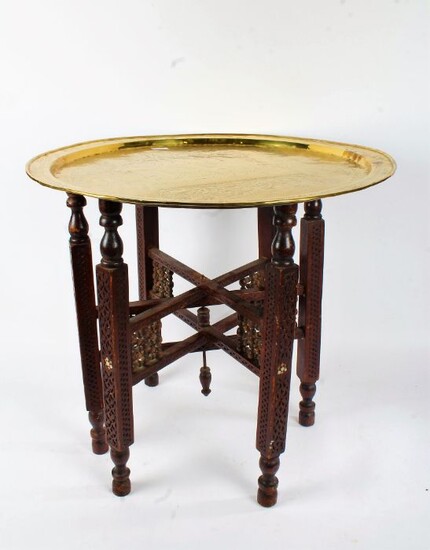 Indian benares brass tray top table, the tray depicting a seated figure with attendants, with