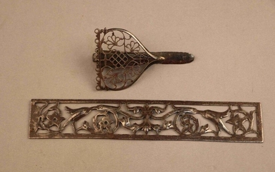 Iron plate with openwork foliage scrolls and belt clip forming a dagger sheath or scissor case with openwork iron of stylized flowers. 18th century.