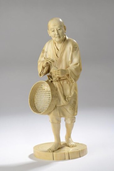 Ivory okimono, standing figure, a matchbox in the...