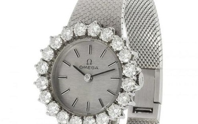 OMEGA watch in white gold and diamonds. Round case with brilliant-cut bezel, silver dial, baton-type